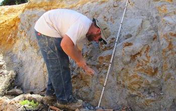 Biogeochemist Keith Morrison sampling an outcrop of blue clay in the Oregon deposit.